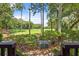Scenic view of the golf course from a private porch with tropical trees and lush greenery at 1326 Sea Elder Dr, Kiawah Island, SC 29455