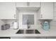 Close up of the sink, faucet, and countertop in the modern kitchen featuring white backsplash at 1326 Sea Elder Dr, Kiawah Island, SC 29455