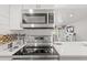Modern kitchen featuring stainless steel appliances, including a microwave and range, set against light, neutral decor at 1326 Sea Elder Dr, Kiawah Island, SC 29455