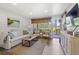 Cozy living room featuring comfortable seating, shiplap walls, and scenic views of the lush green landscape at 1326 Sea Elder Dr, Kiawah Island, SC 29455