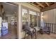 Covered porch offers view into the living room and of the golf course and is tastefully decorated at 1326 Sea Elder Dr, Kiawah Island, SC 29455