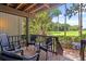 Spacious screened porch with chairs overlooking a lush golf course and tropical foliage at 1326 Sea Elder Dr, Kiawah Island, SC 29455