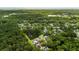 Overhead view of a lush neighborhood featuring homes, a pond, and mature trees at 1431 Whispering Oak Trl, Mount Pleasant, SC 29466