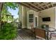 Home's covered back porch with outdoor dining and tv at 1431 Whispering Oak Trl, Mount Pleasant, SC 29466