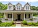 Inviting two-story home featuring a classic front porch and beautiful curb appeal at 1431 Whispering Oak Trl, Mount Pleasant, SC 29466