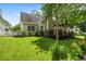 Exterior home view with grassy yard and mature trees at 1431 Whispering Oak Trl, Mount Pleasant, SC 29466