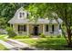 Charming two-story home with a welcoming front porch, black shutters, and a well-manicured lawn at 1431 Whispering Oak Trl, Mount Pleasant, SC 29466