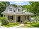 Inviting two-story home featuring a covered front porch and a beautifully landscaped front yard at 1431 Whispering Oak Trl, Mount Pleasant, SC 29466