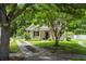 Charming home with a well-manicured lawn, mature trees, and a welcoming front porch at 1431 Whispering Oak Trl, Mount Pleasant, SC 29466