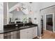 Well-lit kitchen features dark granite counters and stainless steel appliances, connecting to living area with vaulted ceiling at 1431 Whispering Oak Trl, Mount Pleasant, SC 29466