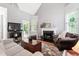 Inviting living room with fireplace, vaulted ceiling, and ample natural light from large windows at 1431 Whispering Oak Trl, Mount Pleasant, SC 29466