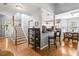 Open-concept living space with hardwood floors, staircase, kitchen with breakfast bar, and dining area at 1431 Whispering Oak Trl, Mount Pleasant, SC 29466