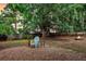 Seating area with shade tree and fire pit in the spacious backyard at 1433 Oaklanding Rd, Mount Pleasant, SC 29464