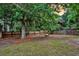 Green backyard featuring a fire pit and mature trees at 1433 Oaklanding Rd, Mount Pleasant, SC 29464