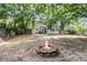 Large backyard featuring a fire pit and mature trees at 1433 Oaklanding Rd, Mount Pleasant, SC 29464
