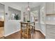 Bright breakfast nook featuring wood floors, a rustic table set, and charming pendant lighting at 1433 Oaklanding Rd, Mount Pleasant, SC 29464