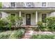 Charming home entrance with detailed trim, a well-manicured lawn, and pathway at 1433 Oaklanding Rd, Mount Pleasant, SC 29464