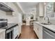 Updated kitchen with stainless appliances, quartz countertops, and an open view to the breakfast nook at 1433 Oaklanding Rd, Mount Pleasant, SC 29464
