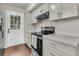 Updated kitchen features sleek cabinetry, modern appliances, and access to the backyard at 1433 Oaklanding Rd, Mount Pleasant, SC 29464