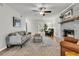 Comfortable living room featuring large rug, neutral paint, brick fireplace, and ceiling fan at 1433 Oaklanding Rd, Mount Pleasant, SC 29464