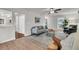 Neutral living room with a large fireplace, ceiling fan, and seating area with a small entry to kitchen at 1433 Oaklanding Rd, Mount Pleasant, SC 29464
