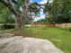 This large backyard is fully fenced with a beautiful mature tree and a patio at 1481 Woodview Ln, Charleston, SC 29412
