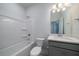 Pristine bathroom featuring a tub, sleek vanity, and a large mirror with modern lighting fixtures at 153 Royal Cainhoy Way, Huger, SC 29450