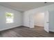 Bright bedroom with hardwood floors, white walls, double doors leading to a closet, and natural light at 153 Royal Cainhoy Way, Huger, SC 29450