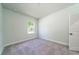 Cozy bedroom with soft gray carpet, white walls, and window creating a serene atmosphere at 153 Royal Cainhoy Way, Huger, SC 29450