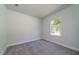 Clean bedroom with a gray carpet, white walls, and a window offering ample natural light at 153 Royal Cainhoy Way, Huger, SC 29450