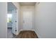 Inviting entryway featuring wood flooring, neutral walls, and a white front door with traditional design at 153 Royal Cainhoy Way, Huger, SC 29450
