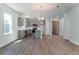 Open-concept kitchen with stainless steel appliances, gray cabinets, and a center island at 153 Royal Cainhoy Way, Huger, SC 29450