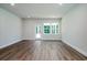 Bright living room featuring wood-look flooring, recessed lighting, and a door leading to the outside at 153 Royal Cainhoy Way, Huger, SC 29450
