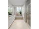 Spacious bathroom with granite countertops, soaking tub, glass shower, and neutral tile at 1532 Sea Palms Cres, Mount Pleasant, SC 29464