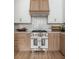 A beautifully designed kitchen featuring custom cabinetry, a professional range, and stylish accents at 1532 Sea Palms Cres, Mount Pleasant, SC 29464