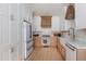 This bright kitchen features custom white and wood cabinets, and stainless steel appliances at 1532 Sea Palms Cres, Mount Pleasant, SC 29464