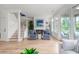 Bright living room features wood floors, fireplace, shiplap accent wall, and access to a patio at 1532 Sea Palms Cres, Mount Pleasant, SC 29464
