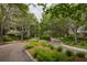Serene street view with lush landscaping, mature trees, and charming homes at 1532 Sea Palms Cres, Mount Pleasant, SC 29464