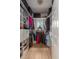 Organized walk-in closet with custom shelving, hanging rods, and a window for natural light at 1532 Sea Palms Cres, Mount Pleasant, SC 29464