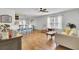 Open-concept living room with wood floors, comfortable seating, and a view of the breakfast bar at 157 Tyger St, Summerville, SC 29485
