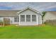 Home's rear exterior with pristine lawn, offering a serene and well-maintained outdoor space at 159 Townsend Way, Summerville, SC 29483