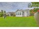 Beautiful home exterior with lush green lawn, screened porch, and fenced yard with blooming tree at 159 Townsend Way, Summerville, SC 29483