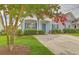 Charming gray home with blue shutters and a well-manicured front yard creates a welcoming curb appeal at 159 Townsend Way, Summerville, SC 29483
