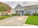 Charming gray home with blue shutters and a well-manicured front yard creates a welcoming curb appeal at 159 Townsend Way, Summerville, SC 29483