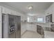 Bright kitchen featuring white cabinets, black appliances, and stylish herringbone backsplash at 159 Townsend Way, Summerville, SC 29483