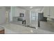 Open kitchen with white cabinets, black appliances, and marble countertops at 159 Townsend Way, Summerville, SC 29483