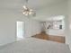 Open-concept living area with hardwood and carpet flooring, connecting to a modern kitchen and dining space at 159 Townsend Way, Summerville, SC 29483