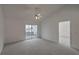 Large primary bedroom with vaulted ceilings, plush carpeting, and access to a sunroom at 159 Townsend Way, Summerville, SC 29483