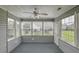 Cozy sun room with large windows, ceiling fan, and carpeted floor for relaxing and enjoying natural light at 159 Townsend Way, Summerville, SC 29483