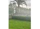 Lush backyard with manicured lawn, a wooden fence, and a large palm tree at 160 Lancashire Rd, Summerville, SC 29486